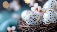 Speckled blue quail eggs with gold spots in natural twig nest against turquoise background with soft bokeh lights. Easter or spring composition.