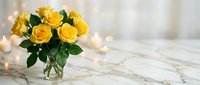 Fresh yellow roses bouquet in glass vase on marble surface with warm bokeh lights creating elegant romantic atmosphere for home decor and celebrations.