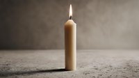 Single burning candle with warm flame on textured surface against soft gray background creating peaceful ambiance for meditation and relaxation concepts.