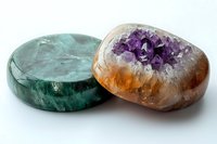 Green fluorite polished disc and amethyst geode specimen on white background showcase natural crystal formations and mineral textures in vibrant colors.