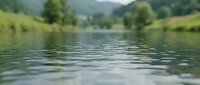 Serene river landscape with lush green meadows and forested hills reflecting in calm water, suitable for nature, travel, and environmental design projects.