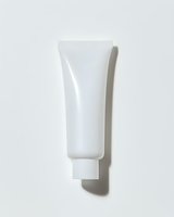 White cosmetic tube on light background with natural shadow. Clean minimal product packaging mockup for skincare, beauty or medical cream design.