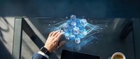 Generated image of a professional male hand interacting with a holographic blue cube network structure floating above a laptop, representing data technology, artificial intelligence, and digital innovation in a modern workspace.