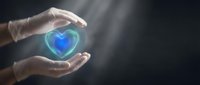 Protective hands surrounding glowing blue heart symbol representing healthcare insurance coverage and medical protection services.