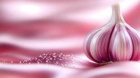 Fresh whole garlic bulb with scattered pink salt crystals on soft pink gradient background, artistic food photography composition for culinary designs.