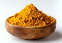 Vibrant turmeric powder heaped in wooden bowl against white background, popular spice used in cooking and natural medicine.