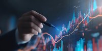 Businessman analyzing financial market data with pen pointing at rising stock chart graph on digital screen in dark office environment.
