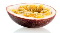 Fresh passion fruit half with juicy pulp and seeds isolated on white background for healthy eating and tropical cuisine designs.