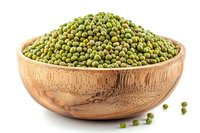 Fresh mung beans in wooden bowl, raw organic legumes for healthy cooking and plant-based protein source.