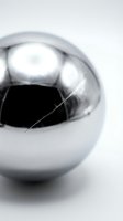 Cracked chrome sphere with visible fracture line on white background showing metallic reflection and surface damage for design concepts.