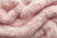 Soft pink faux fur fabric with gentle folds creating waves and shadows, luxurious textile background for fashion and interior design projects.