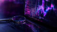 Magnifying glass on laptop keyboard with financial chart data in purple and blue neon colors reflecting market analysis and stock trading visualization.