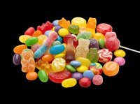 Colorful assorted candy pile with gummy bears, jelly beans, lollipops, and sugar sweets, isolated on transparent background, ready for stickers, clipart, and print on demand.