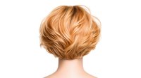 Back view of short layered blonde bob hairstyle with feathered texture and natural highlights on white background, isolated for hair and beauty industry use.