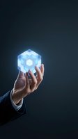 Businessman hand holding glowing blue cube with digital blocks on dark background, representing technology innovation, data processing, and business solutions for corporate presentations.
