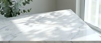 Marble tabletop with dappled sunlight and shadows from foliage, ideal for product placement, lifestyle photography, and interior design projects.