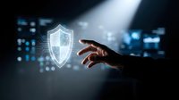 Hand reaching toward glowing digital security shield icon in dark tech environment representing cybersecurity protection and data safety solutions.