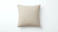 Beige linen throw pillow with subtle texture and piped edges, isolated on white background, for interior design and home decor projects.
