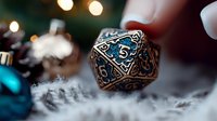 Ornate copper-colored gaming dice with glowing blue numbers floating over white winter decorations and bokeh lights in magical atmospheric setting.