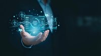 Businessman hand holding holographic digital interface with renewable energy icons and data analytics for sustainable technology solutions.