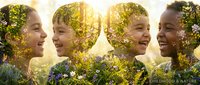 Four diverse children laughing joyfully with double exposure of green foliage and flowers creating magical nature connection during golden hour sunlight.