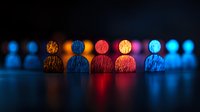 Colorful silhouettes of people figures in a row illuminated by vibrant neon lights creating reflection on dark surface, representing diversity and teamwork concept.