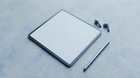 Modern digital tablet with stylus pen on concrete surface for creative work and digital art projects.