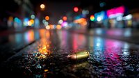 Crime scene investigation with bullet casing on wet asphalt street at night with colorful city lights bokeh background for forensic evidence documentation.