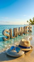 Summer word made of stone letters standing in turquoise ocean waves on sandy beach with straw hat, sunglasses, palm trees and sailboats.