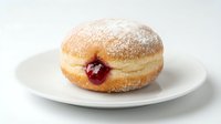Freshly baked jelly-filled donut dusted with powdered sugar on white plate, perfect for bakery, food photography, and dessert marketing materials.