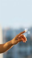 Hand touching digital interface icons in modern office environment with blurred city background for business technology presentations.