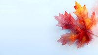 Vibrant red and orange maple leaf on soft blue background with delicate watercolor effect creates serene autumn mood for seasonal designs and decor.