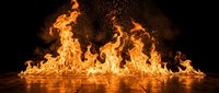 Dramatic orange flames dancing with intense heat and sparks against dark background. Powerful fire element for energy, passion, and dynamic design concepts.