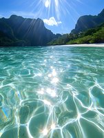 Sunlight sparkles on crystal clear turquoise water at secluded tropical beach cove, dramatic mountain cliffs frame pristine shoreline, tranquil summer paradise.