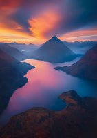 Dramatic mountain peak rises above misty lake at sunset, with vibrant orange clouds reflecting in calm waters surrounded by autumn forest landscape.