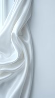 Flowing white silk fabric with elegant drapes and soft folds creating luxurious texture against neutral background for fashion and textile design projects.