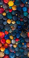 Colorful abstract spheres with glowing elements create dynamic pattern in red, blue and gold tones, featuring textured surfaces and dramatic lighting effects.