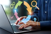Businessman hands typing on laptop with colorful digital workflow arrows and business process icons floating above keyboard in modern office.