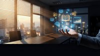 Businessman holding digital icons representing education, analytics, and online learning in modern office with city skyline view through windows.