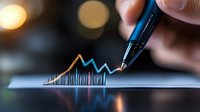 Financial graph showing market growth trend line drawn with blue pen on paper, with blurred bokeh lights in background creating professional atmosphere.