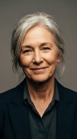 Senior woman with long gray hair and warm smile wearing black blazer and shirt against neutral background, suitable for corporate, business, professional portraits, and lifestyle editorial use.