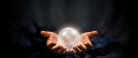 Hands holding glowing orb against dark background, mystical energy sphere for fortune telling, magic, spirituality, and supernatural concepts.