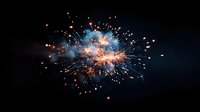 Spectacular firework explosion with bright orange sparks and blue smoke against dark night sky, creating dynamic light trails and glowing particles.