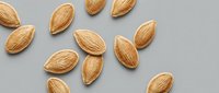 Raw almonds scattered on neutral background for healthy snacking and cooking ingredients in kitchen recipes and nutritious meal preparation.