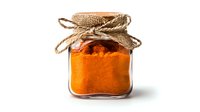 Ground turmeric powder in glass jar with burlap lid and twine bow on white background, aromatic spice for cooking and natural medicine.