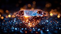 Brilliant cut diamond with warm glowing light and bokeh effects on dark background with sparkles and reflections. Luxury jewelry concept.