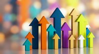 Colorful upward arrows in various sizes creating growth and success concept on blurred bokeh background for business presentations and financial reports.