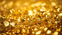 Shimmering golden glitter background with blurred bokeh effect and sparkling metallic particles creating luxurious festive texture for holiday designs.
