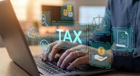 Professional accountant working on laptop with digital tax management interface displaying financial icons and legal symbols for business compliance.