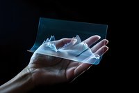 Transparent holographic mountain landscape floating above open palm in dark setting, glowing with ethereal blue light creates futuristic visualization effect.